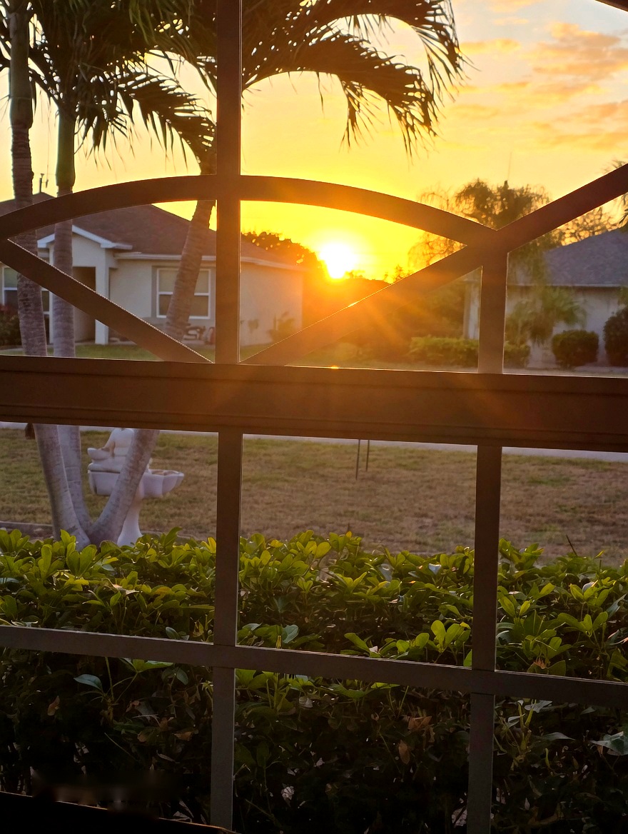 Sunset view through the lanai at 4116 SW 6th Place